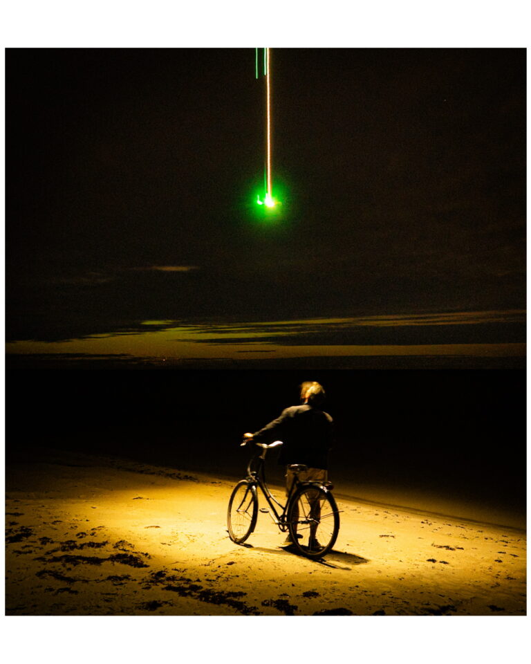 Astonishing photo of the Northern Lights. The cyclist standing in the mysterious light.