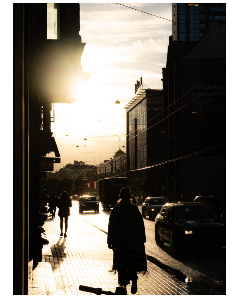 A woman walking on a central street of Riga. A high contrast photo.